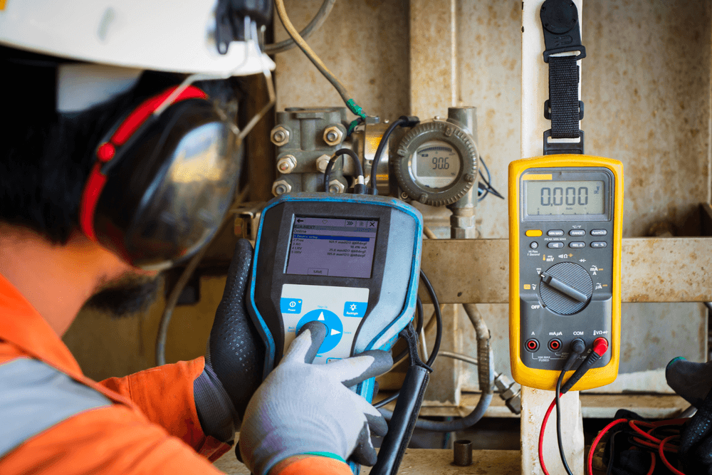 Engineer calibrating field instrumentation at an industrial site