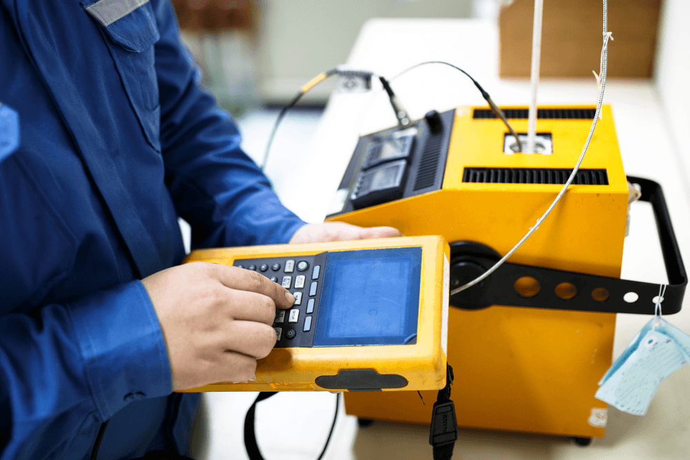 Technician operating industrial calibration equipment