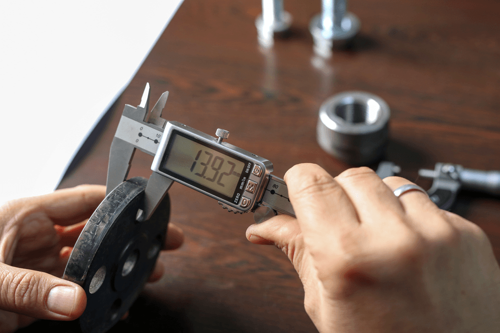 Digital caliper measuring a precision machined component